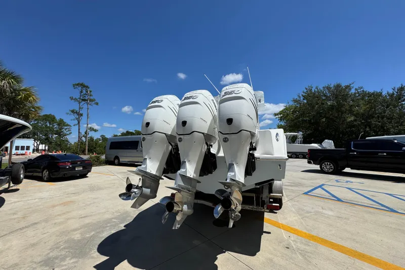 Slide: The Image of 2021 Invincible 36 Open Fisherman with triple outboard engines in a parking lot. - 15