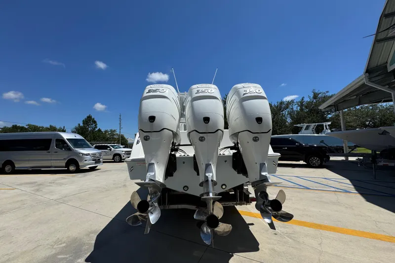 Slide: The Image of 2021 Invincible 36 Open Fisherman with triple 350 engines in a parking lot. - 16