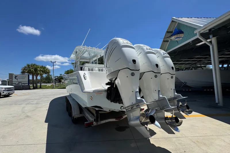 Slide: The Image of 2021 Invincible 36 Open Fisherman boat with triple outboard engines in a sunny marina. - 17