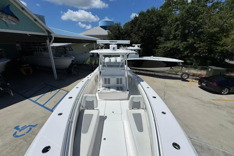 Slide: The Image of 2021 Invincible 36 Open Fisherman boat at a marina under a clear blue sky. - 24