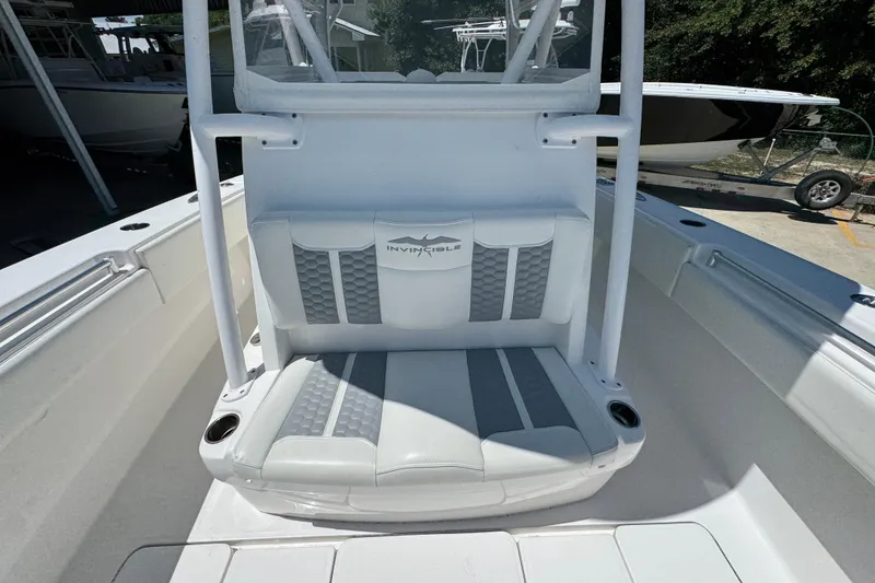 Slide: The Image of 2021 Invincible 36 Open Fisherman boat seating area with logo and cup holders. - 26