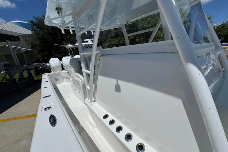 Slide: The Image of 2021 Invincible 36 Open Fisherman boat, sleek white design, docked outdoors. - 28