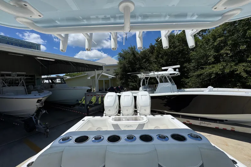 Slide: The Image of 2021 Invincible 36 Open Fisherman boat with triple engines in a marina setting. - 32