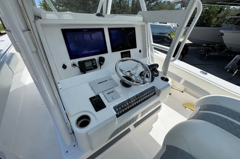 Slide: The Image of 2021 Invincible 36 Open Fisherman boat console with dual screens and steering wheel. - 33