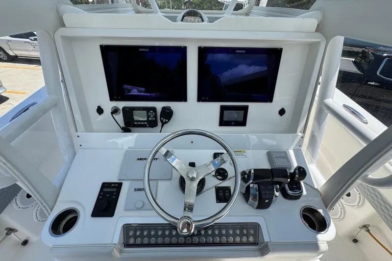 Slide: The Image of 2021 Invincible 36 Open Fisherman helm with dual Simrad displays and Mercury controls. - 34