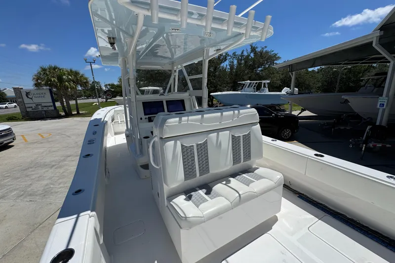 Slide: The Image of 2021 Invincible 36 Open Fisherman boat with seating and console, parked outdoors under clear sky. - 37