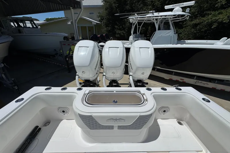 Slide: The Image of 2021 Invincible 36 Open Fisherman with triple outboard engines in a marina setting. - 41