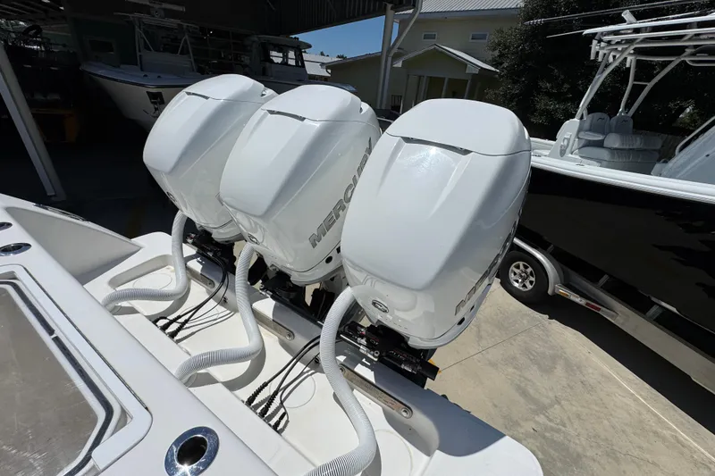 Slide: The Image of Triple Mercury outboard engines on a 2021 Invincible 36 Open Fisherman boat. - 42