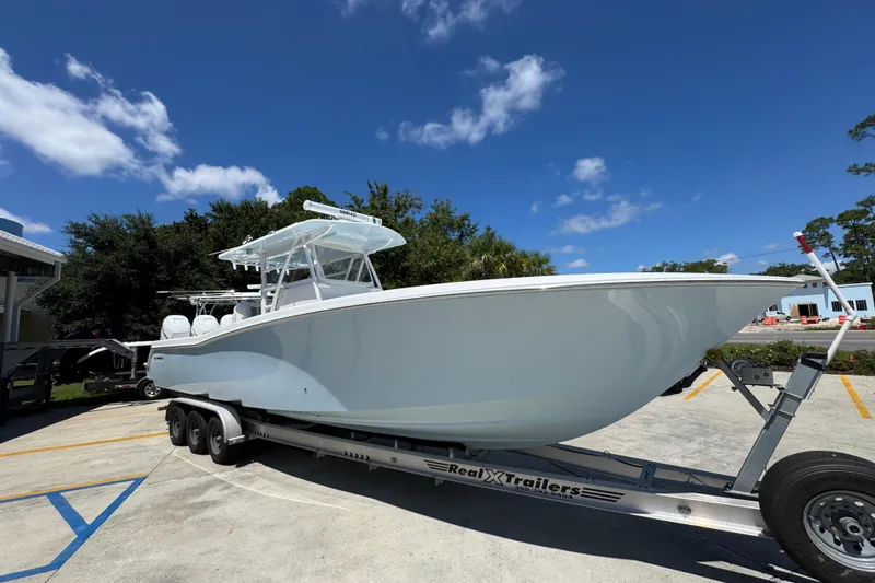 Slide: The Image of 2021 Invincible 36 Open Fisherman boat on trailer under clear blue sky. - 9