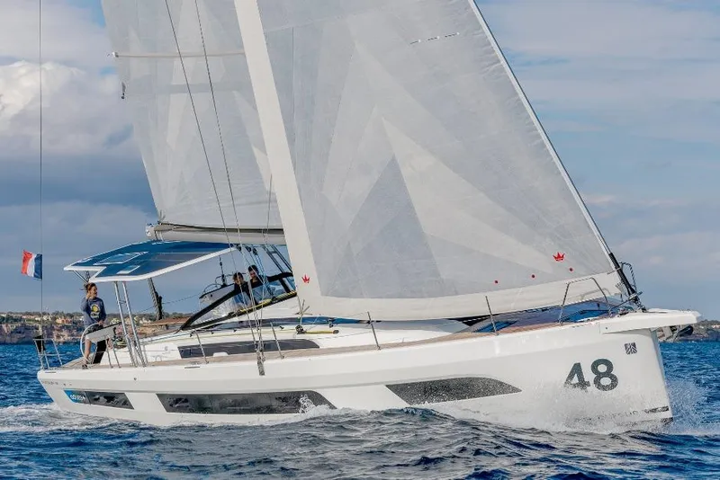 Slide: The Image of 2026 Dufour 48 sailing yacht on open water, showcasing sleek design and performance. - 22