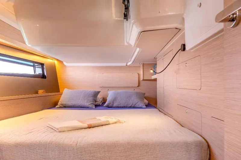 Slide: The Image of Luxurious cabin interior of 2026 Dufour 48 yacht with cozy bedding and modern design. - 32