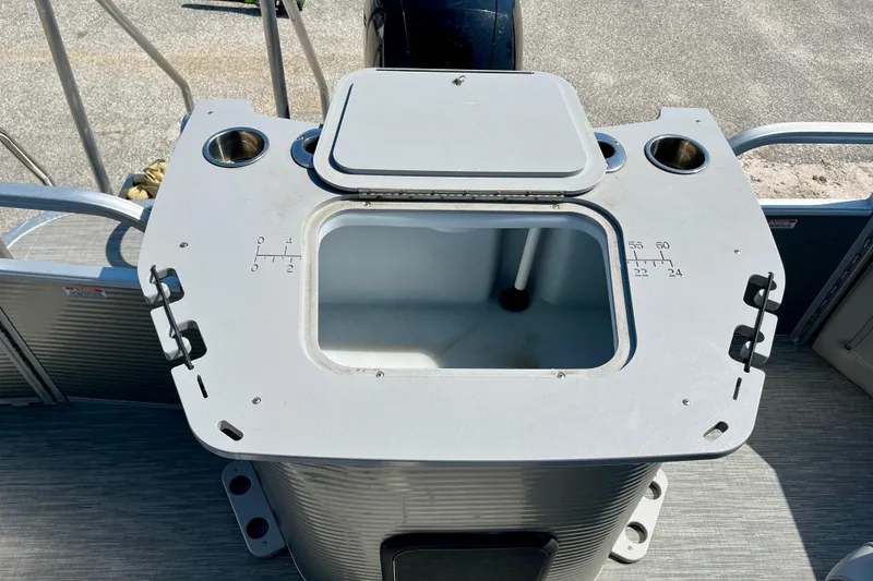 Slide: The Image of 2023 Bennington SX23 boat console with storage compartment and cup holders. - 10