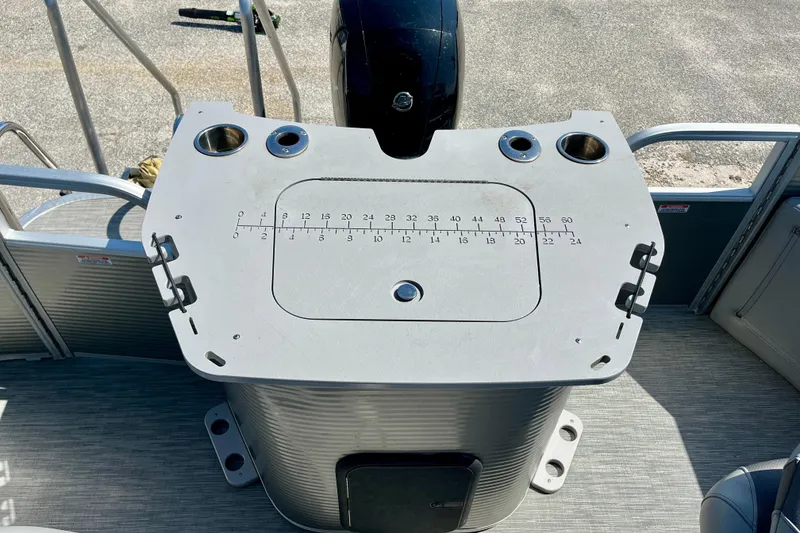 Slide: The Image of 2023 Bennington SX23 boat console with cup holders and measurement markings. - 11