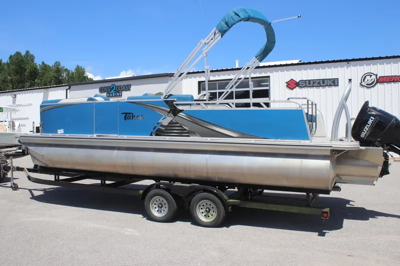 Slide: The Image of 2021 Tahoe Pontoon LTZ Versatile Rear Bench 24' on trailer at marine dealership. - 2