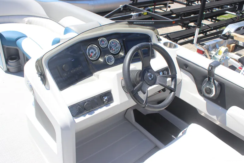 Slide: The Image of 2021 Tahoe Pontoon LTZ Versatile Rear Bench 24' dashboard with steering wheel and controls. - 4
