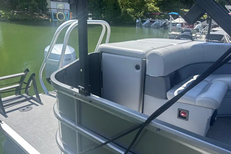 Slide: The Image of 2025 Bentley Pontoons Legacy Cruise XL on a serene lake, showcasing luxurious seating and sleek design. - 11