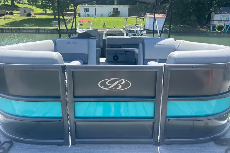 Slide: The Image of 2025 Bentley Pontoons Legacy Cruise XL with luxurious seating and sleek design on a serene lake. - 9