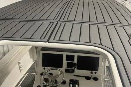 Slide: The Image of 2022 Prowler 31 boat interior with sleek white seating and stainless steel fixtures. - 16