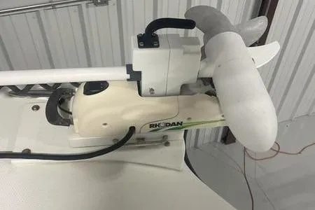 Slide: The Image of 2022 Prowler 31 boat on trailer under cloudy sky. - 2