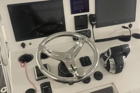 Slide: The Image of 2022 Prowler 31 boat with white seating and spacious deck in a sunny outdoor setting. - 4