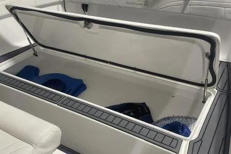 Slide: The Image of 2022 Prowler 31 boat interior with white cushioned seating and stainless steel accents. - 8