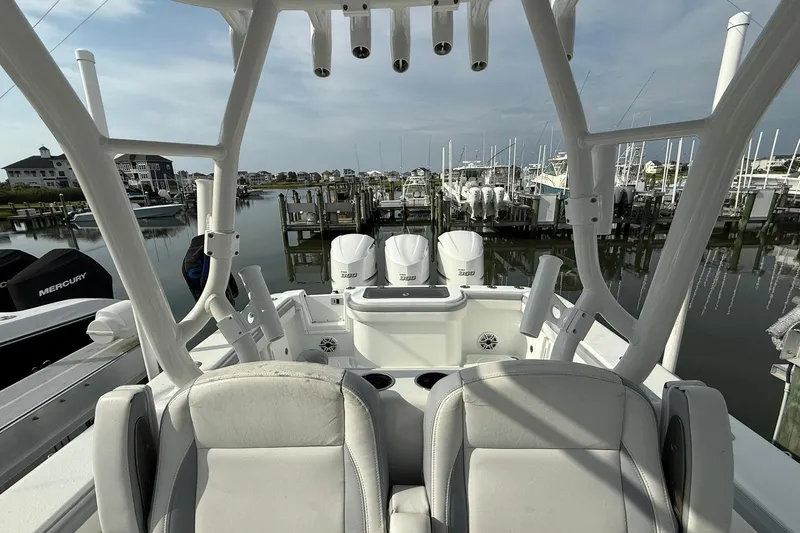 Slide: The Image of 2021 Yellowfin 36 Offshore boat interior with helm and seating, docked at marina. - 10