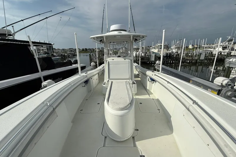 Slide: The Image of 2021 Yellowfin 36 Offshore boat docked, featuring spacious seating and sleek design. - 12