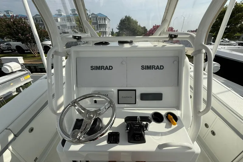 Slide: The Image of 2021 Yellowfin 36 Offshore boat interior with seating and controls at marina. - 13