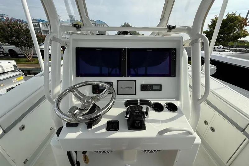 Slide: The Image of 2021 Yellowfin 36 Offshore boat interior with helm, rod holders, and seating. - 14