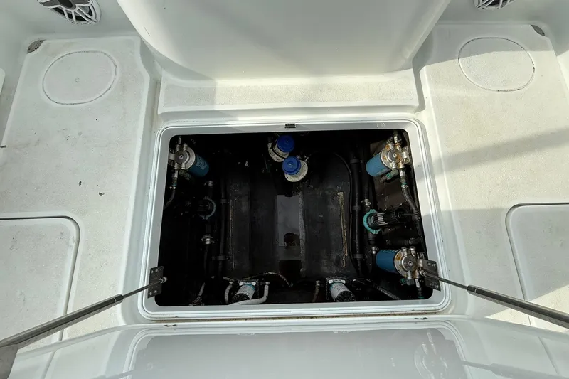 Slide: The Image of 2021 Yellowfin 36 Offshore boat seating area with white cushions and rod holders. - 15