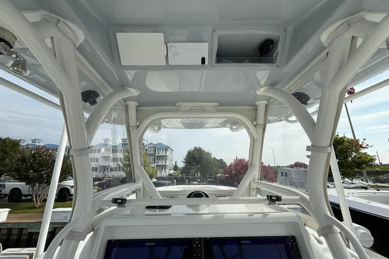 Slide: The Image of 2021 Yellowfin 36 Offshore boat helm with dual screens and steering wheel. - 18