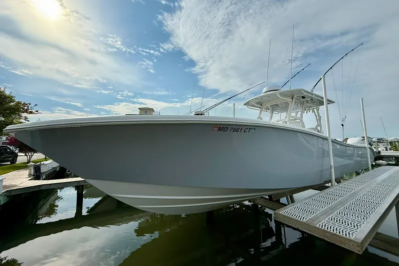 Slide: The Image of 2021 Yellowfin 36 Offshore boat cruising at sunset on calm waters. - 2
