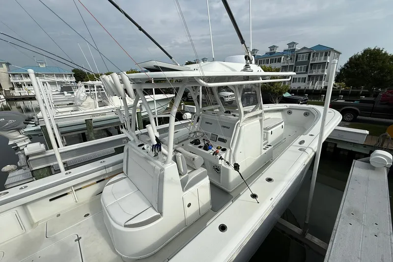 Slide: The Image of 2021 Yellowfin 36 Offshore boat interior with seating and console, docked at marina. - 20