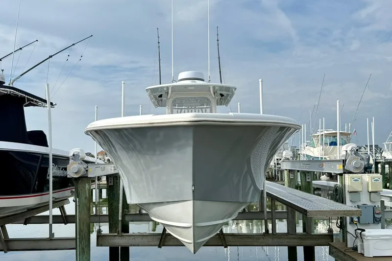 Slide: The Image of 2021 Yellowfin 36 Offshore boat docked at marina, featuring triple engines. - 24