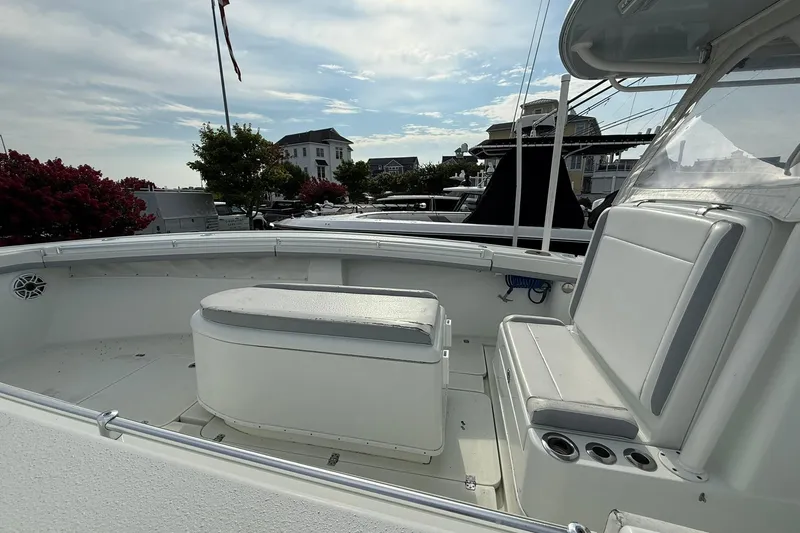 Slide: The Image of 2021 Yellowfin 36 Offshore boat on water at sunset, featuring dual outboard motors. - 3