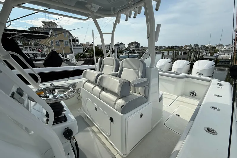 Slide: The Image of 2021 Yellowfin 36 Offshore boat interior with seating and storage, dockside view. - 5