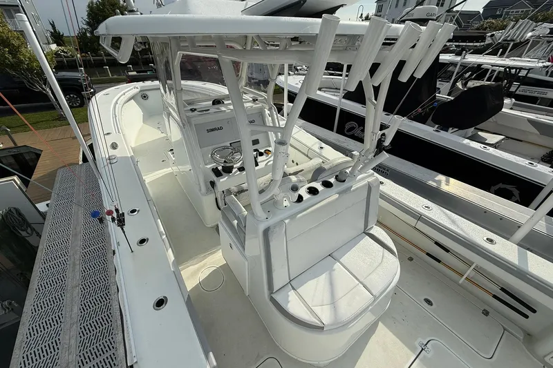 Slide: The Image of 2021 Yellowfin 36 Offshore boat with triple outboard engines at sunset on the water. - 7