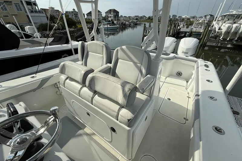 Slide: The Image of 2021 Yellowfin 36 Offshore boat at sunset near waterfront homes. - 9