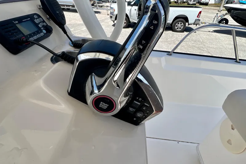 Slide: The Image of 2023 Boston Whaler 210 Montauk boat controls with start/stop button and radio. - 15