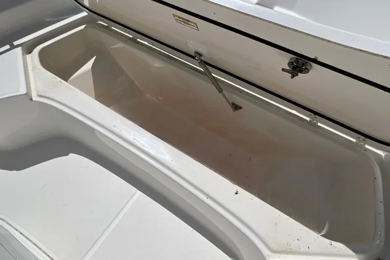 Slide: The Image of Open storage compartment on a 2023 Boston Whaler 210 Montauk boat. - 19