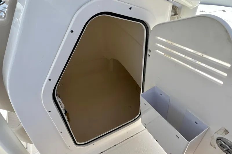 Slide: The Image of Storage compartment on a 2023 Boston Whaler 210 Montauk boat, open door view. - 20