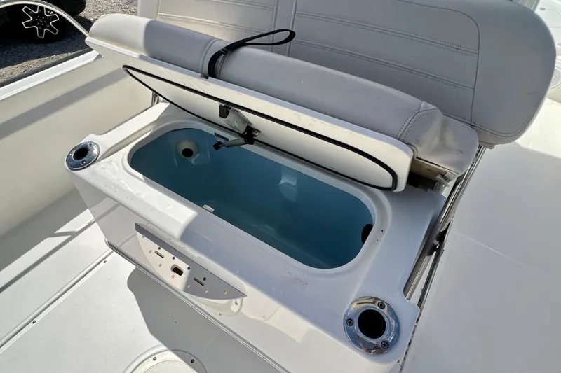 Slide: The Image of 2023 Boston Whaler 210 Montauk boat seat with open storage compartment. - 22