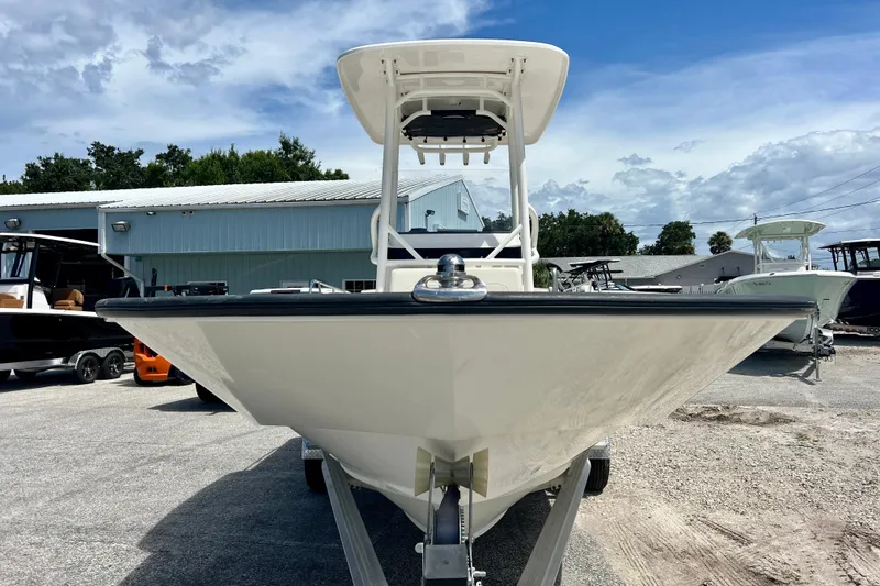 Slide: The Image of 2023 Boston Whaler 210 Montauk boat on trailer, outdoor display under blue sky. - 3