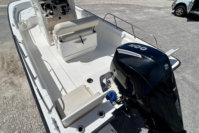 Slide: The Image of 2023 Boston Whaler 210 Montauk boat with powerful outboard motor, spacious deck, and modern controls. - 8