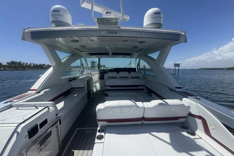 Slide: The Image of 2020 Formula 430 Super Sport Crossover boat cruising on a calm waterway. - 10