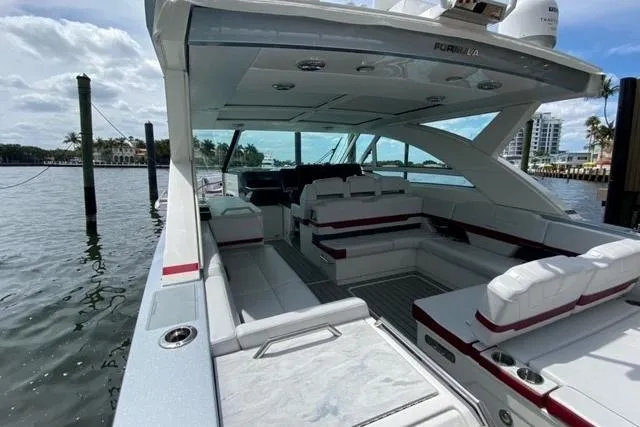 Slide: The Image of 2020 Formula 430 Super Sport Crossover boat cruising on a calm waterway. - 12