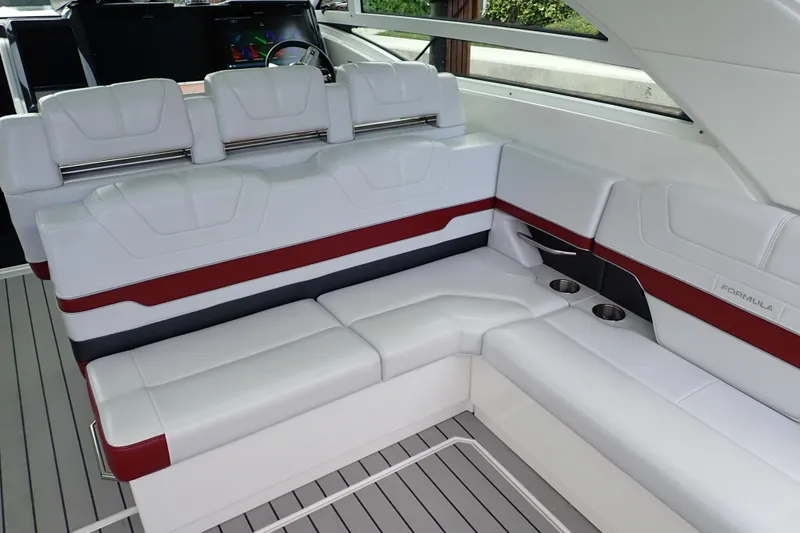 Slide: The Image of 2020 Formula 430 Super Sport Crossover boat docked in a serene marina setting. - 15