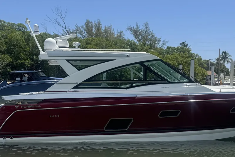 Slide: The Image of 2020 Formula 430 Super Sport Crossover cruising on open water under clear blue skies. - 4