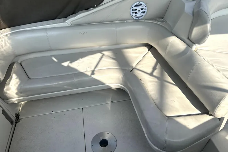 Slide: The Image of 2001 Regal Commodore 2960 boat interior with white leather seating and speaker. - 12