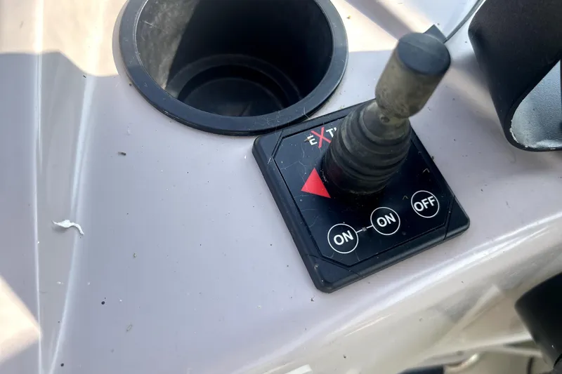 Slide: The Image of Control panel of a 2001 Regal Commodore 2960 boat with joystick and cup holder. - 17